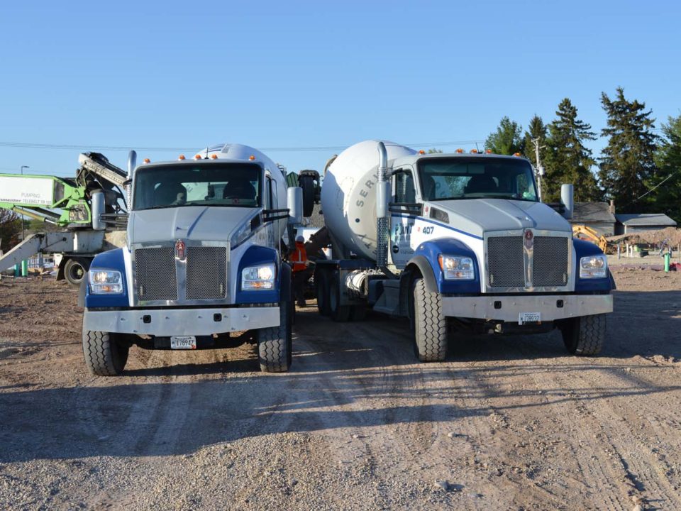 two cement mixing trucks